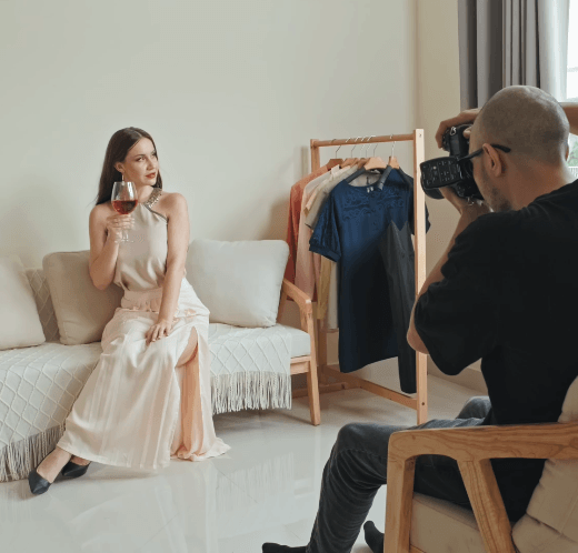 The woman receiving a photo shoot from a photographer